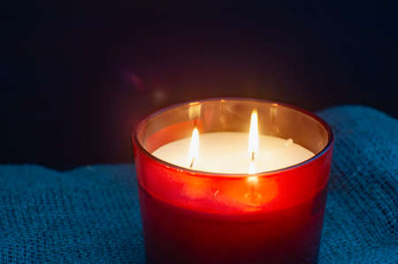 Burning candles on dark surface. memory day. red.の写真素材