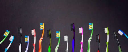 a lot of toothbrushes isolated on a black background, the concept of a poster background for text.の写真素材