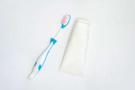 toothbrushes for adults and children and a tube of paste on an isolated white background. with a place to insert textの写真素材