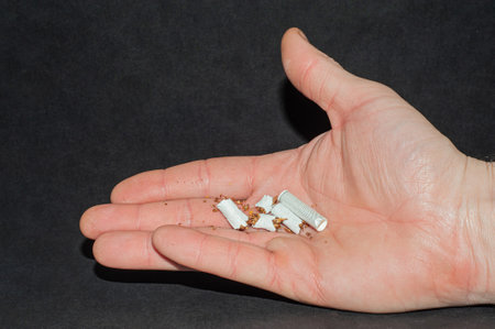 Broken pile of cigarettes in a woman's hand. Quit smoking.の写真素材