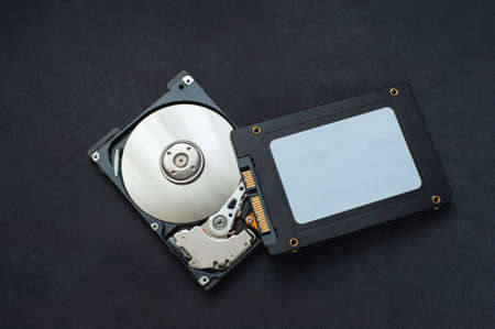 Macro view of an HDD head resting on a disk platter and its reflection.の写真素材