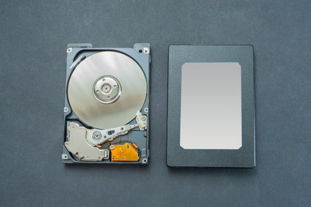 Macro view of an HDD head resting on a disk platter and its reflection.の写真素材
