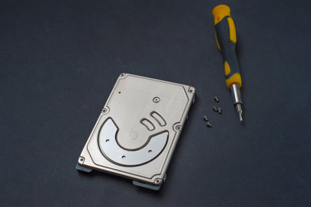 Engineer fixing broken computer hard disc. Electronic repair shop, technology development concept.の写真素材
