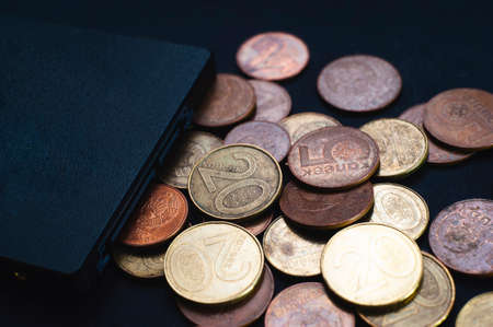 A bunch of coins, on a black background, and a solid-state drive, the growth, the fall in the price of memory.の写真素材