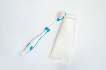 toothbrushes for adults and children and a tube of paste on an isolated white background. with a place to insert textの写真素材