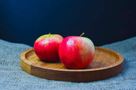 Still life with green apples on a platter on a wooden table.の写真素材
