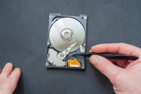 Engineer fixing broken computer hard disc. Electronic repair shop, technology development concept.