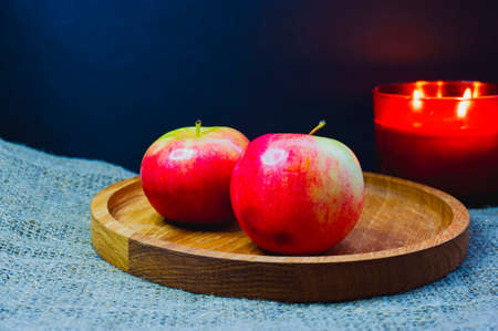 Still life with green apples on a platter on a wooden table.の写真素材