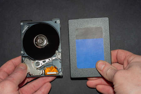 Engineer fixing broken computer hard disc. Electronic repair shop, technology development concept.の写真素材