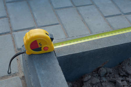 Measuring tape scale yellow roll construction tool inch centimeters size, meter equipament work precise.の写真素材