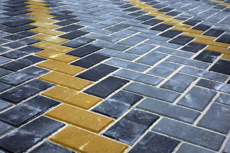 Paving slabs of different colors and shapes.Texture of different colored patterned paving slabs . Modern road surface.の写真素材