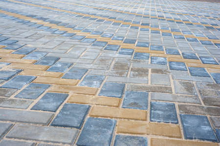 Paving slabs of different colors and shapes.Texture of different colored patterned paving slabs . Modern road surface.の写真素材