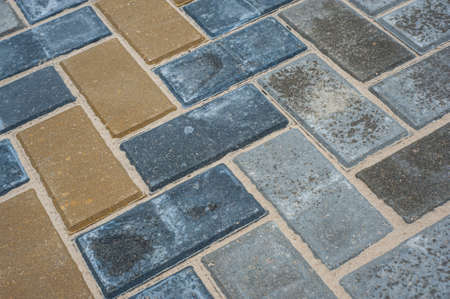 Paving slabs of different colors and shapes.Texture of different colored patterned paving slabs .の写真素材