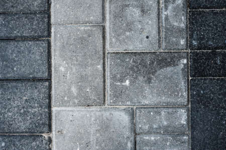 Laying gray concrete paving stones on house courtyard textureの写真素材