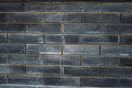 Black brick wall texture. Aged stone block masonry. Dark glow background vintageの写真素材