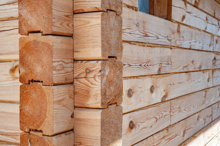 Wood cabin or mountain chalet house. Wood shortage and wood price surge affect the price of wooden houses. Construction cottage from wooden beams.の写真素材