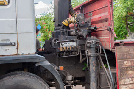 Unloading paving slabs from a truck. Men unload paving slabs using a manipulator.の写真素材
