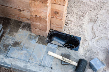 Gutter, gutter, drain for water after rain on the sidewalk. Installation of paving slabs and drainage systems. sidewalk construct.の写真素材