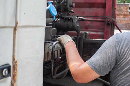 Unloading paving slabs from a truck. Men unload paving slabs using a manipulator.の写真素材