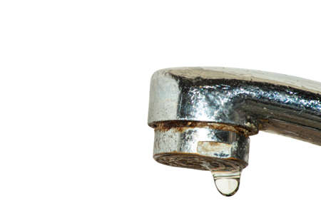 Tap closeup with dripping water-drop. Water leaking, saving concept.の写真素材