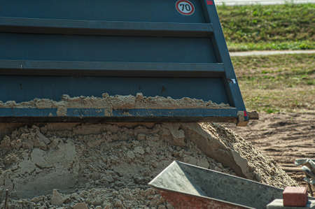 Dump trucks carrying good filling a field, giving rise to a fine soil. Preparation and construction. Cityの写真素材