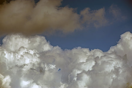 Puffy white cloud on clear blue sky.の写真素材