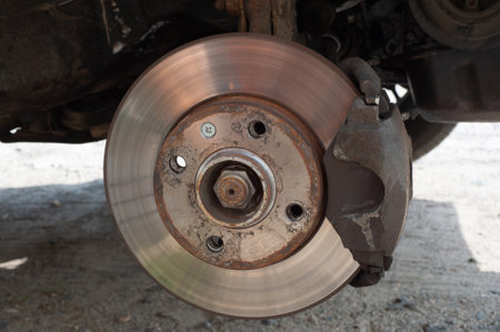 Close up Rear brake caliper and disk with jack kit of car service tool for check brake pads and brake disc thickness, Initial inspection by yourself of car service concept.の写真素材
