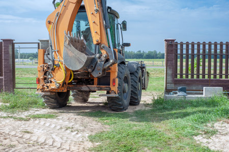 Excavator bucket close-up on the background of a construction site. Heavy earthmoving equipment. Soil development.の写真素材