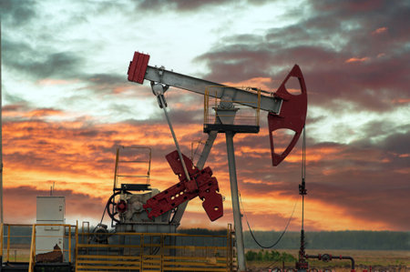 Oil pump oil rig energy industrial machine for petroleum in the sunset backgroundの写真素材