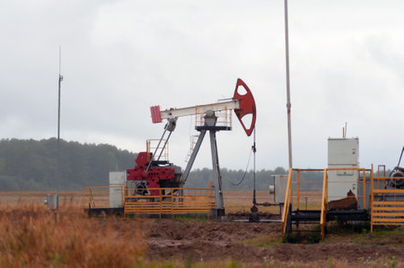 Oil pump oil rig energy industrial machine for petroleum in the sunset backgroundの写真素材