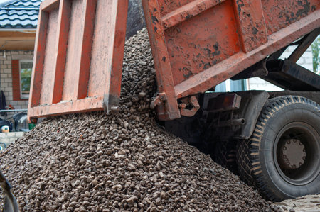 Dump trucks carrying good filling a field, giving rise to a fine soil. Preparation and construction. Cityの写真素材