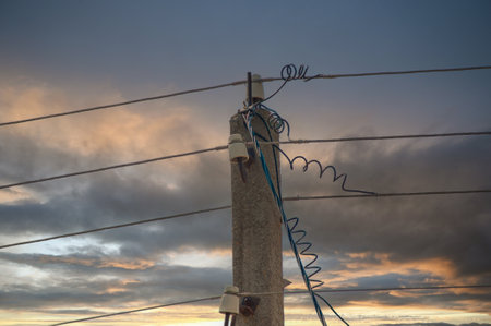 Electric lines overhead, power lines against bles sky.の写真素材