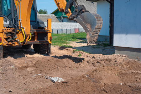 Excavator bucket close-up on the background of a construction site. Heavy earthmoving equipment. Soil development.の写真素材