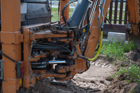 Excavator bucket close-up on the background of a construction site. Heavy earthmoving equipment. Soil development.の写真素材