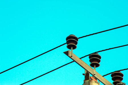 Power electric pole with line wire on colored background close up, photography consisting of power electric pole with line wire under sky, line wire in power electric pole for residential buildingsの写真素材