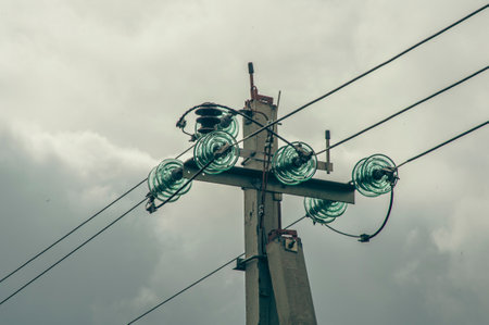 Power electric pole with line wire on colored background close up, photography consisting of power electric pole with line wire under sky, line wire in power electric pole for residential buildingsの写真素材