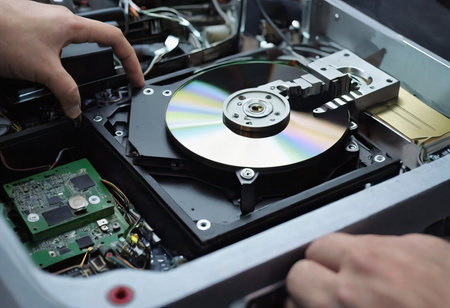 The abstract image of inside of hard disk drive on the technician's desk and a computer motherboard as a component. the concept of data, hardware, and information technology.の素材