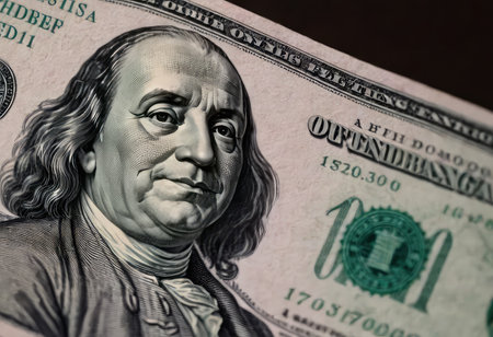 This is a closeup view of a ten dollar bill featuring the image of Benjamin Franklin prominently displayed on its surfaceの素材