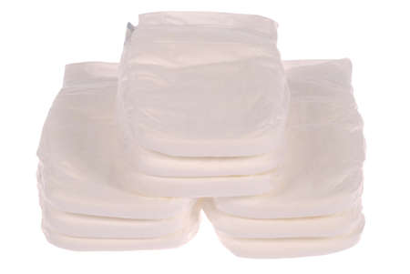 Stack of baby diapers on white. Clipping path included.の写真素材