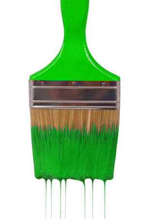 A paintbrush dripping with green paint isolated on white  の写真素材