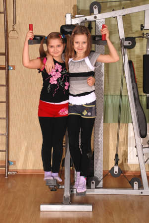 Fitness team  Two children posing in a gym の写真素材