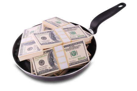 Abstract concept. Dollars in frying pan isolated on white with clipping path.の写真素材