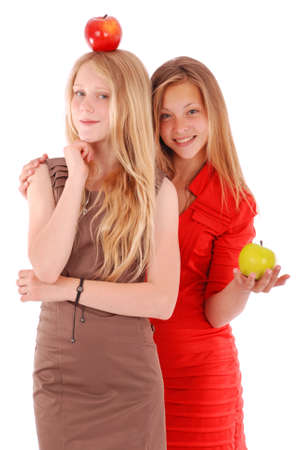 Two girls holding fresh apples isolated on whiteの写真素材