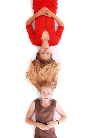 Portrait two girls with intertwined hairs, isolated on whiteの写真素材
