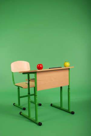 New school desk and chair on green backgroundの写真素材