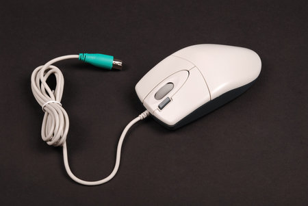White computer optical mouse isolated on black background with soft shadow