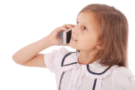 Portrait of beautiful happy young girl talking on smartphone isolated on whiteの写真素材