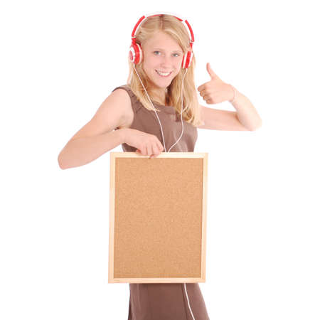 Teenage girl in headphones, holding cork board. Isolated on white backgroundの写真素材