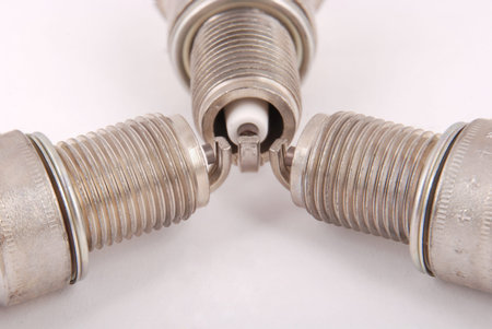 Three new spark plug on a gray background
