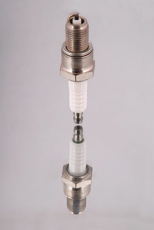 One new spark plugs on a mirror background